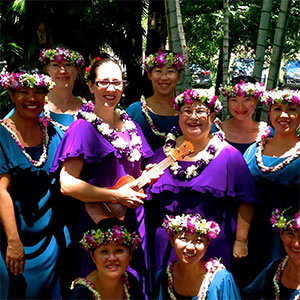 Na Hula Ola Aloha group members outside wearing lei