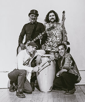 black and white photo of Quadraphonix band members with instruments