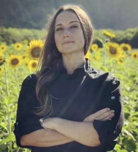 Headshot of Chef Katie standing in a field of flowers